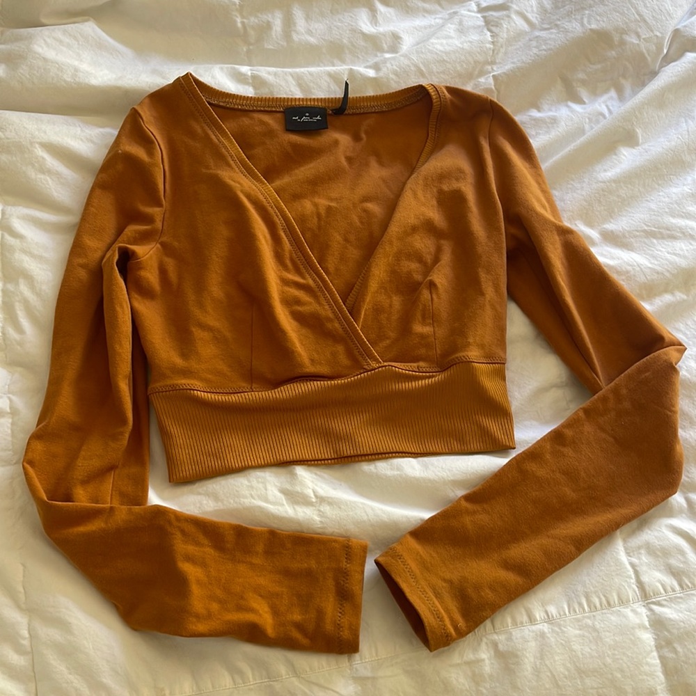 Orange urban outfitters wrap top with thumb holes!In great condition worn twice